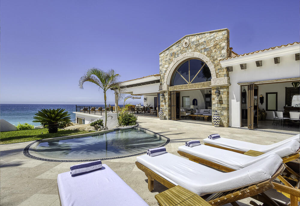 Los Cabos Rancholasmargaritas Casa Playa Escondida - Oceanfront Luxury in Baja California SurPerched dramatically on the rocks above the Pacific Ocean, Casa Playa Escondida is a rare oceanfront retreat set along a secluded, pristine stretch of beach. Located within the exclusive off-grid gated community of Rancho Las Margaritas, this one-of-a-kind property offers privacy, tranquility, and breathtaking natural beauty--just a 20-minute drive to the dining and shopping of Cabo San Lucas, 40 minutes from Los Cabos International Airport, and approximately 30 minutes south of Cerritos and Todos Santos.The residence features three spacious ensuite bedrooms, each privately situated yet connected by terraces, pathways, and shared gathering spaces. A dedicated media room offers flexibility as a fourth bedroom or additional guest suite.Expansive terraces and multiple lounging areas provide a variety of vantage points to take in the surrounding landscape, from the rugged coastline to the endless Pacific horizon.The gourmet kitchen is equipped with high-end appliances and designed for both functionality and style. A warm and inviting living and dining area, anchored by a striking fireplace, creates the perfect space for entertaining or relaxing with family and friends. The home is offered fully furnished with includes modern off-grid conveniences such as solar power.Outdoor living is equally exceptional, featuring a swimming pool, firepit, grilling area, and multiple seating spaces--ideal for enjoying the serene coastal setting – 3 Demasias de la Laguna, San Jose del Cabo, BS