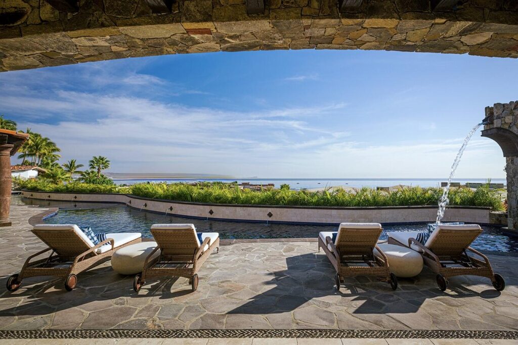 Los Cabos Rancholasmargaritas Casa Playa Escondida - Oceanfront Luxury in Baja California SurPerched dramatically on the rocks above the Pacific Ocean, Casa Playa Escondida is a rare oceanfront retreat set along a secluded, pristine stretch of beach. Located within the exclusive off-grid gated community of Rancho Las Margaritas, this one-of-a-kind property offers privacy, tranquility, and breathtaking natural beauty--just a 20-minute drive to the dining and shopping of Cabo San Lucas, 40 minutes from Los Cabos International Airport, and approximately 30 minutes south of Cerritos and Todos Santos.The residence features three spacious ensuite bedrooms, each privately situated yet connected by terraces, pathways, and shared gathering spaces. A dedicated media room offers flexibility as a fourth bedroom or additional guest suite.Expansive terraces and multiple lounging areas provide a variety of vantage points to take in the surrounding landscape, from the rugged coastline to the endless Pacific horizon.The gourmet kitchen is equipped with high-end appliances and designed for both functionality and style. A warm and inviting living and dining area, anchored by a striking fireplace, creates the perfect space for entertaining or relaxing with family and friends. The home is offered fully furnished with includes modern off-grid conveniences such as solar power.Outdoor living is equally exceptional, featuring a swimming pool, firepit, grilling area, and multiple seating spaces--ideal for enjoying the serene coastal setting – Villa Encanto, Palmilla Cove 5, San Jose Corridor, San Jose Corridor, BS
