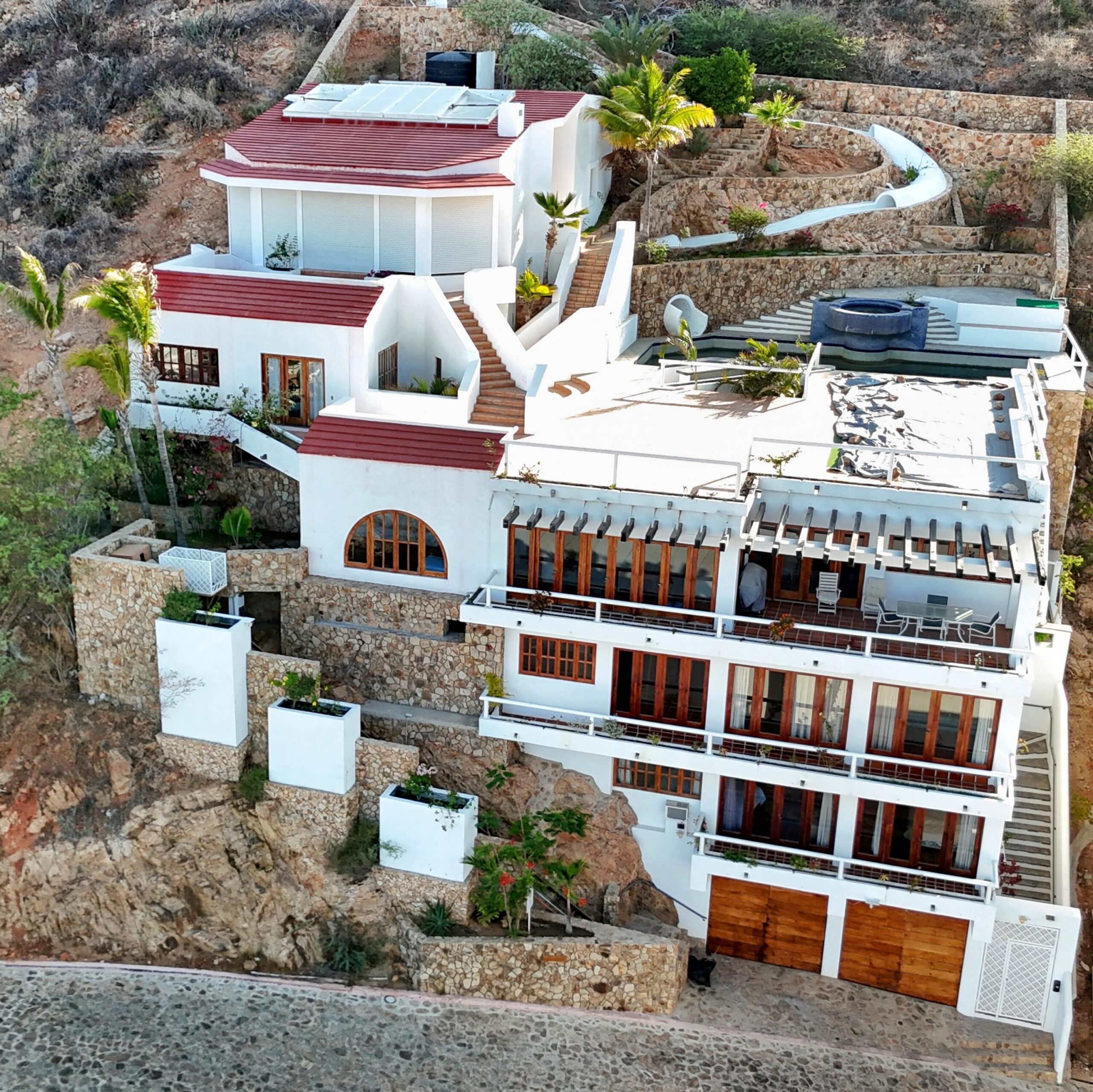 Los Cabos Pedregal Csl Perched high above the marina and the Sea of Cortez, this extraordinary 10,000-square-foot estate is one of Pedregal's most iconic residences. Carved into the granite hillside, the property represents a remarkable piece of Cabo San Lucas history and offers an architectural experience unlike any other in Los Cabos.Panoramic – 115 Cam. Grande, Cabo San Lucas, BS